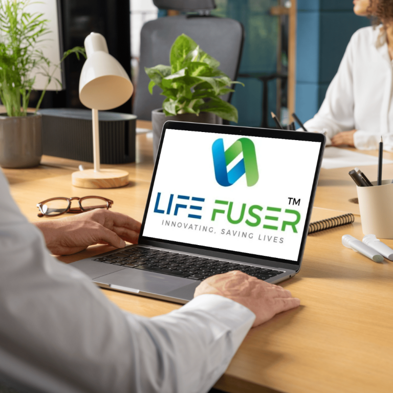 LIFEFUSER – Transforming Transplant Care with Technology A professional working on a laptop showing the LIFEFUSER transplant software logo in a modern healthcare office environment.